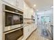 Bright kitchen features stainless steel appliances, white cabinets, and granite countertops at 2676 Estuary Loop, Oviedo, FL 32765