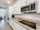 Kitchen with white cabinets, granite countertops, and stainless-steel microwave at 2676 Estuary Loop, Oviedo, FL 32765