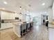 Open kitchen boasts an island with bar seating, pendant lights, and stainless appliances at 2676 Estuary Loop, Oviedo, FL 32765