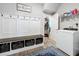 Well-organized laundry room includes a bench with storage and a walk-in closet for convenience at 2676 Estuary Loop, Oviedo, FL 32765