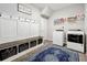 Functional laundry room with a bench seat, storage baskets, and modern washer/dryer units at 2676 Estuary Loop, Oviedo, FL 32765