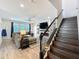 Comfortable living room featuring a fireplace and a view of the staircase at 2676 Estuary Loop, Oviedo, FL 32765