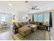 Bright living room with a spacious sectional sofa and view of the dining area, creating a warm atmosphere at 2676 Estuary Loop, Oviedo, FL 32765