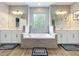 Bright bathroom features a double vanity, large window and soaking tub at 2676 Estuary Loop, Oviedo, FL 32765