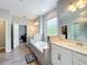 Bright bathroom features a double vanity, glass shower and soaking tub at 2676 Estuary Loop, Oviedo, FL 32765