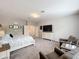 Spacious main bedroom featuring carpet flooring, TV and sitting area at 2676 Estuary Loop, Oviedo, FL 32765