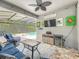 Relaxing screened-in patio includes a pool view and comfortable blue wicker seating at 2676 Estuary Loop, Oviedo, FL 32765