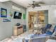Comfortable covered patio features wicker furniture, a TV, and a mini fridge perfect for entertaining at 2676 Estuary Loop, Oviedo, FL 32765