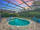Inviting screened in pool with built-in sun loungers and ample patio space, with a beautiful sunset view at 2676 Estuary Loop, Oviedo, FL 32765