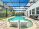 Inviting screened in pool features built-in sun loungers, and a large patio overlooking private, lush landscaping at 2676 Estuary Loop, Oviedo, FL 32765