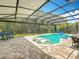 An inviting screened in pool with built-in sun loungers and ample patio space surrounded by lush landscaping at 2676 Estuary Loop, Oviedo, FL 32765