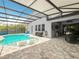 An inviting screened in pool with built-in sun loungers and ample patio space for outdoor living at 2676 Estuary Loop, Oviedo, FL 32765