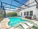 An inviting screened in pool features built-in sun loungers, ample patio space, and well-maintained landscaping at 2676 Estuary Loop, Oviedo, FL 32765