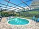 Inviting screened in pool with built-in sun loungers and ample patio space, with a tranquil backyard view at 2676 Estuary Loop, Oviedo, FL 32765