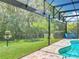 Inviting backyard pool with screened enclosure, pool-side seating, and lush greenery at 2676 Estuary Loop, Oviedo, FL 32765