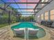 Inviting screened in pool features built-in sun loungers, and a large patio with colorful sunset views at 2676 Estuary Loop, Oviedo, FL 32765