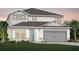 Charming two-story home with gray and white paint, well-manicured lawn, and a two-car garage at 3118 Norcott Dr, Davenport, FL 33837