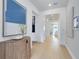 Bright and airy hallway with light wood floors, white walls, and stylish decor at 3118 Norcott Dr, Davenport, FL 33837