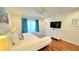 Inviting bedroom with blue curtains, a white dresser, and a comfortable king bed at 3129 Arrow Dr, Kissimmee, FL 34746