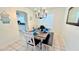 Cozy dining area with a modern chandelier, a wood table, and a bench with stylish decor at 3129 Arrow Dr, Kissimmee, FL 34746