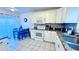 Bright kitchen with white cabinets, granite countertops, and tile flooring next to an eat-in space at 3129 Arrow Dr, Kissimmee, FL 34746