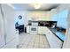 Well-lit kitchen with white cabinets, granite countertops, and modern appliances at 3129 Arrow Dr, Kissimmee, FL 34746