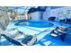 Tranquil backyard featuring a private pool, comfortable lounge chairs, and a screened enclosure at 3129 Arrow Dr, Kissimmee, FL 34746