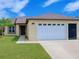 Charming single-story home features a well-maintained lawn, inviting entrance, and a convenient two-car garage at 3260 Pinto Dr, Kissimmee, FL 34746