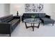 Stylish living room with modern furnishings, including a sleek leather sofa, contemporary art, and a glass-top coffee table at 3260 Pinto Dr, Kissimmee, FL 34746