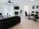 Bright living area with neutral tile flooring, fireplace, modern ceiling fan, and sliding doors to the backyard at 3260 Pinto Dr, Kissimmee, FL 34746