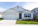 Charming single-Gathering home features a two-car garage, manicured lawn, and inviting entrance, perfect for suburban living at 3412 Wynwood Forest Dr, Ocoee, FL 34761