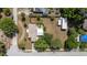 Aerial view showcasing a home with a spacious backyard and lush landscaping and street access at 360 W University Ave, Orange City, FL 32763