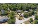 An aerial of the home, situated amongst lush trees in a well established neighborhood with quiet streets at 360 W University Ave, Orange City, FL 32763
