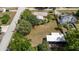 Aerial view highlighting a home on a large lot with mature trees providing shade and privacy at 360 W University Ave, Orange City, FL 32763