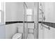 Modern bathroom featuring tile flooring and walls, a toilet and a shower with glass door at 360 W University Ave, Orange City, FL 32763