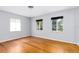 Inviting bedroom with hardwood floors and ample natural light from two windows at 360 W University Ave, Orange City, FL 32763