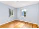 Bright bedroom with natural lighting, hardwood floors and two windows at 360 W University Ave, Orange City, FL 32763
