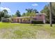 A beautiful home surrounded by mature trees and landscaping at 360 W University Ave, Orange City, FL 32763