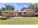 Charming one-story home with a welcoming front yard and manicured landscaping at 360 W University Ave, Orange City, FL 32763