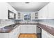 Bright kitchen with white cabinets, granite countertops, and stainless steel appliances at 360 W University Ave, Orange City, FL 32763