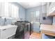 Functional laundry room featuring a utility sink and modern washer and dryer at 360 W University Ave, Orange City, FL 32763