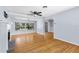 Bright living room featuring hardwood floors, a fireplace, and ample natural light at 360 W University Ave, Orange City, FL 32763
