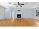 Open-concept living area with hardwood floors, fireplace, and plenty of natural light at 360 W University Ave, Orange City, FL 32763