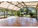 Expansive screened-in patio with tile flooring and lush landscaping, perfect for outdoor entertaining at 360 W University Ave, Orange City, FL 32763