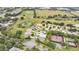 Community aerial view featuring residential streets, green spaces, recreational courts, and nearby golf course at 4002 Richmond Xing, Leesburg, FL 34748