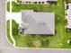 Drone eye view of a home showcasing the roof, manicured landscaping, and surrounding neighborhood streets at 4002 Richmond Xing, Leesburg, FL 34748