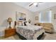 Cozy bedroom with a ceiling fan, a painting, and a comfortable couch at 4002 Richmond Xing, Leesburg, FL 34748