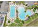 Overhead shot of community pools, including a lap pool and leisure pool, complemented by decorative landscaping at 4002 Richmond Xing, Leesburg, FL 34748