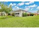 Beautifully landscaped home featuring lush green grass and vibrant, colorful bushes at 4002 Richmond Xing, Leesburg, FL 34748