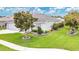 Charming home exterior showcasing lush landscaping, a well-manicured lawn, and a welcoming facade at 4002 Richmond Xing, Leesburg, FL 34748